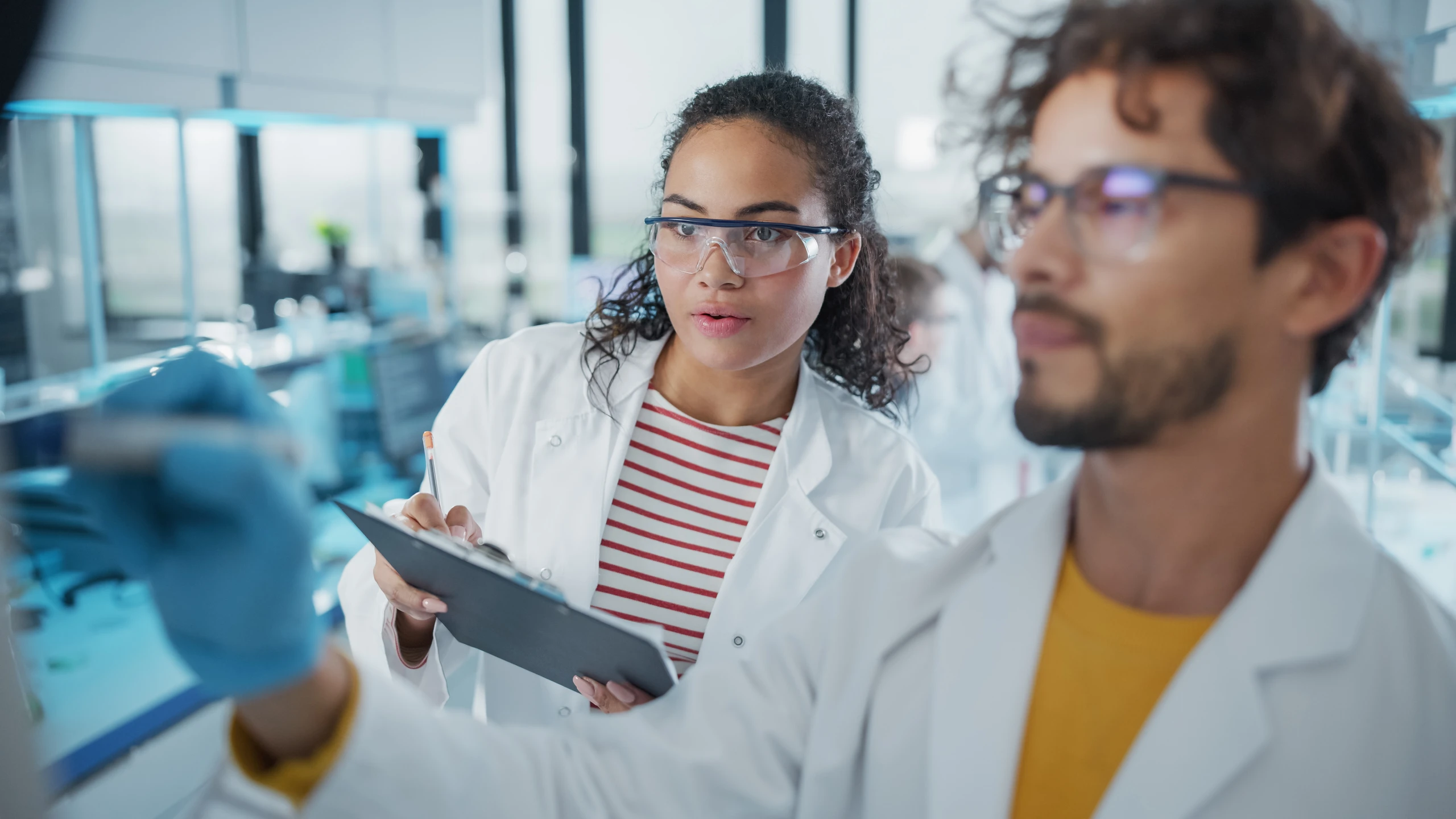 Dois estudantes de biomedicina trabalhando em um laboratório científico