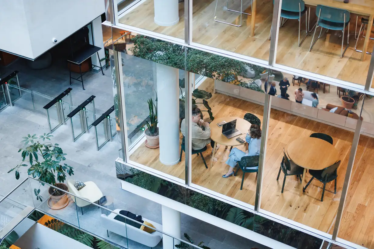 Profissionais trabalhando em um moderno escritório de arquitetura com layout aberto e design contemporâneo