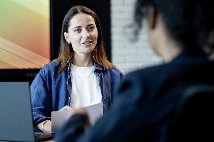 Mulher jovem profissional durante uma entrevista de emprego ou reunião de trabalho em escritório