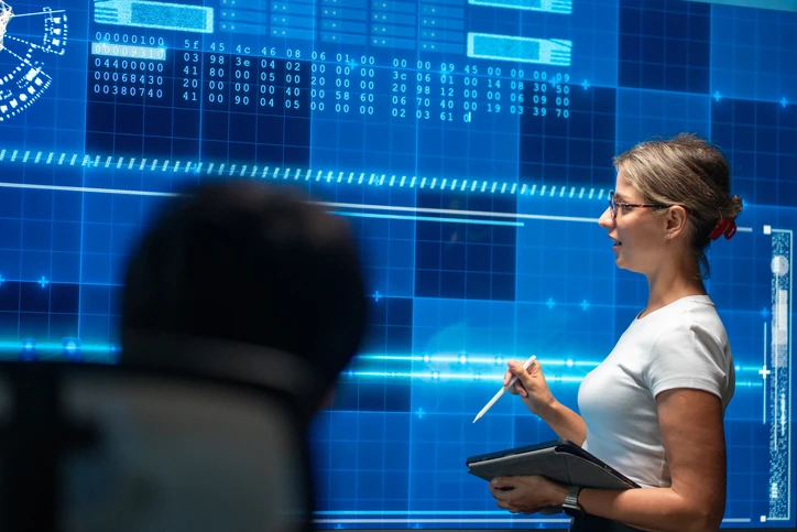 Especialista em tecnologia apresenta análise de dados complexos em painel digital moderno para estudantes ou equipe técnica