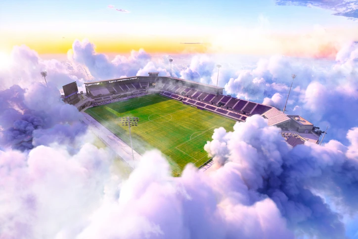 https://estaticos.animaeducacao.com.br/medias/20260629114428/GettyImages-2255109556.webp Vista aérea surreal de um estádio de futebol cercado por nuvens em um cenário onírico e inspirador