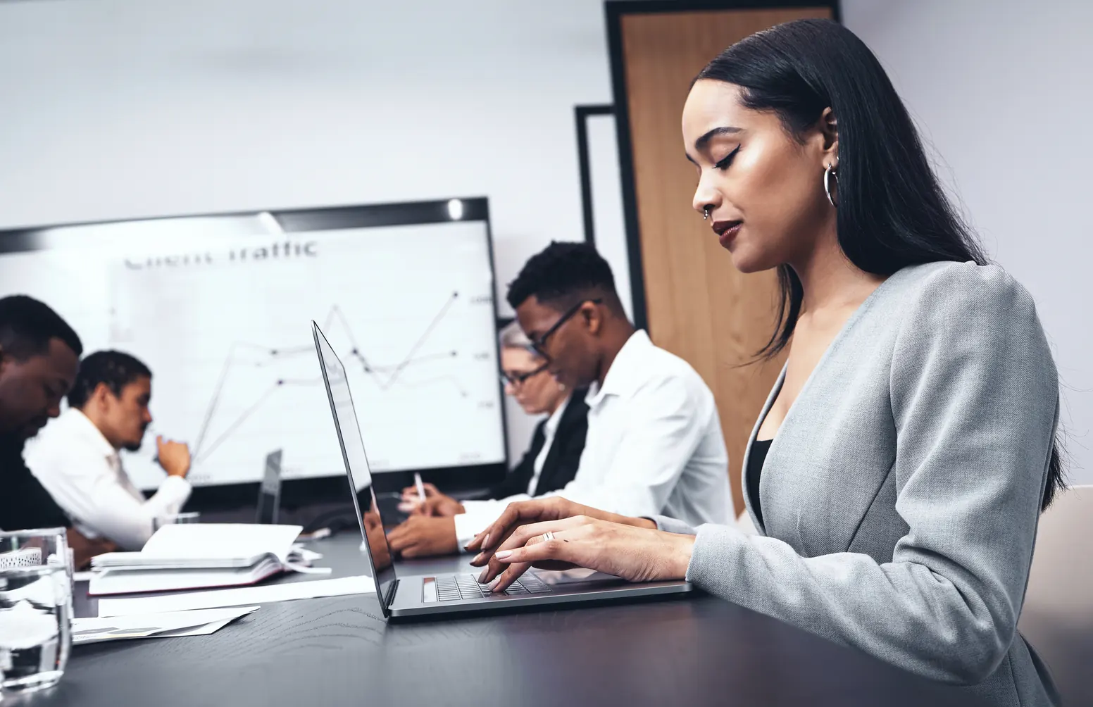 Shot of a young businesswoman using her laptop in the office